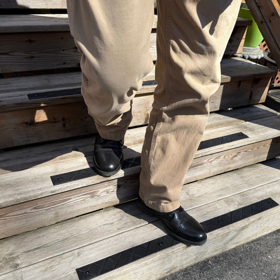 ComposiGrip black non-slip stair strips on wooden stairs